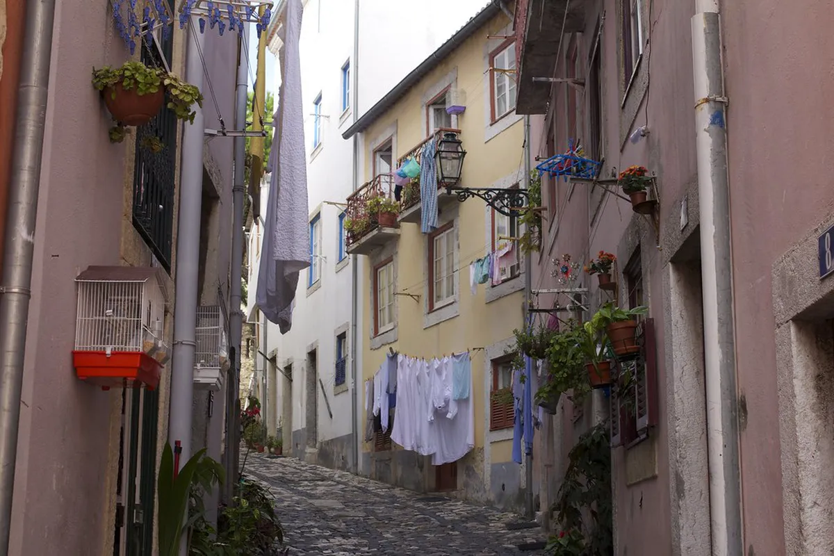 Laundry strung across a narrow Alfama alley