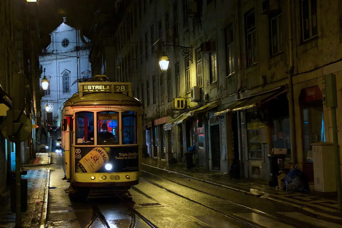 Yellow Tram 28 climbing through Alfama