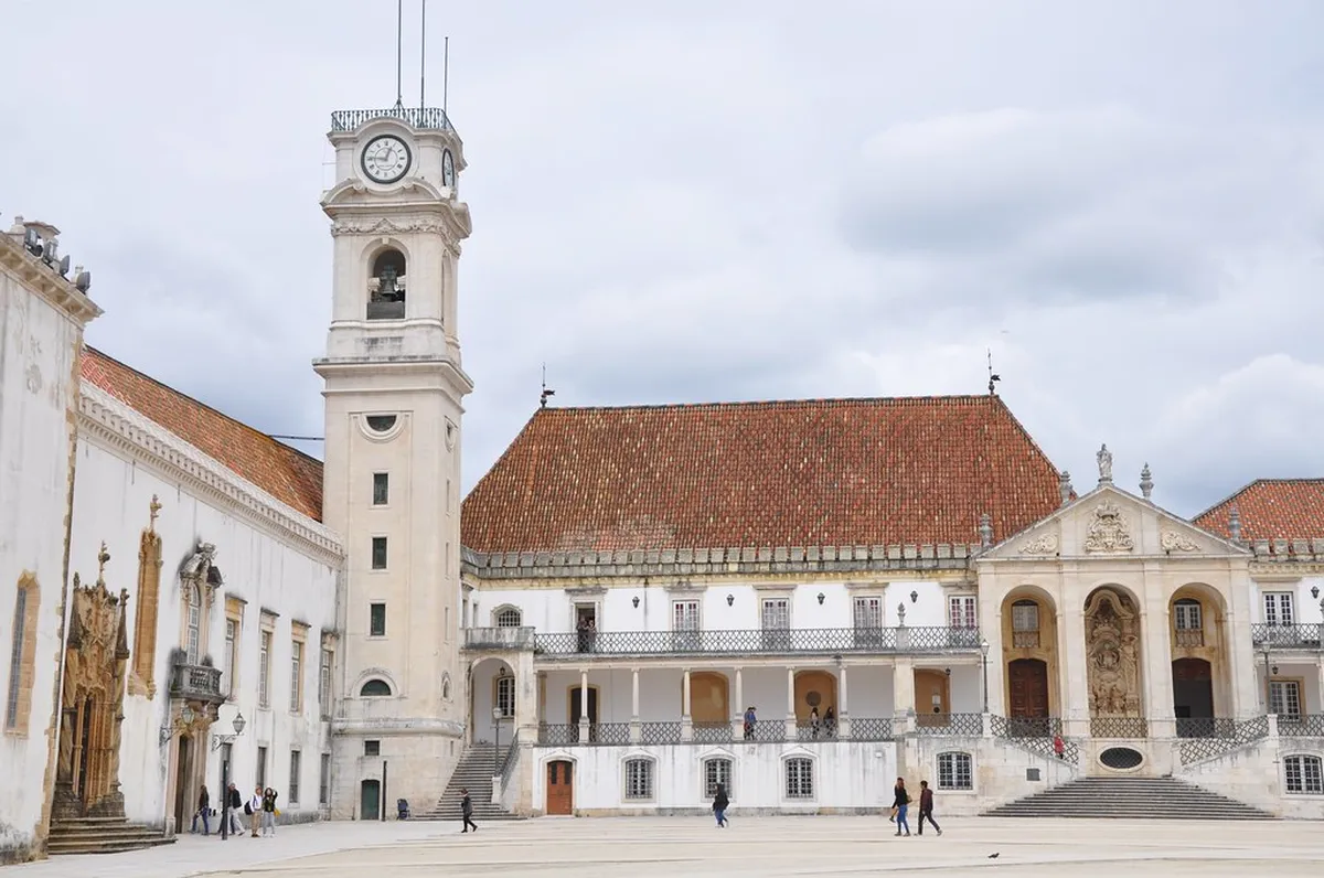 Torre da Universidade rising above Coimbra's historic rooftops with sweeping views of the city