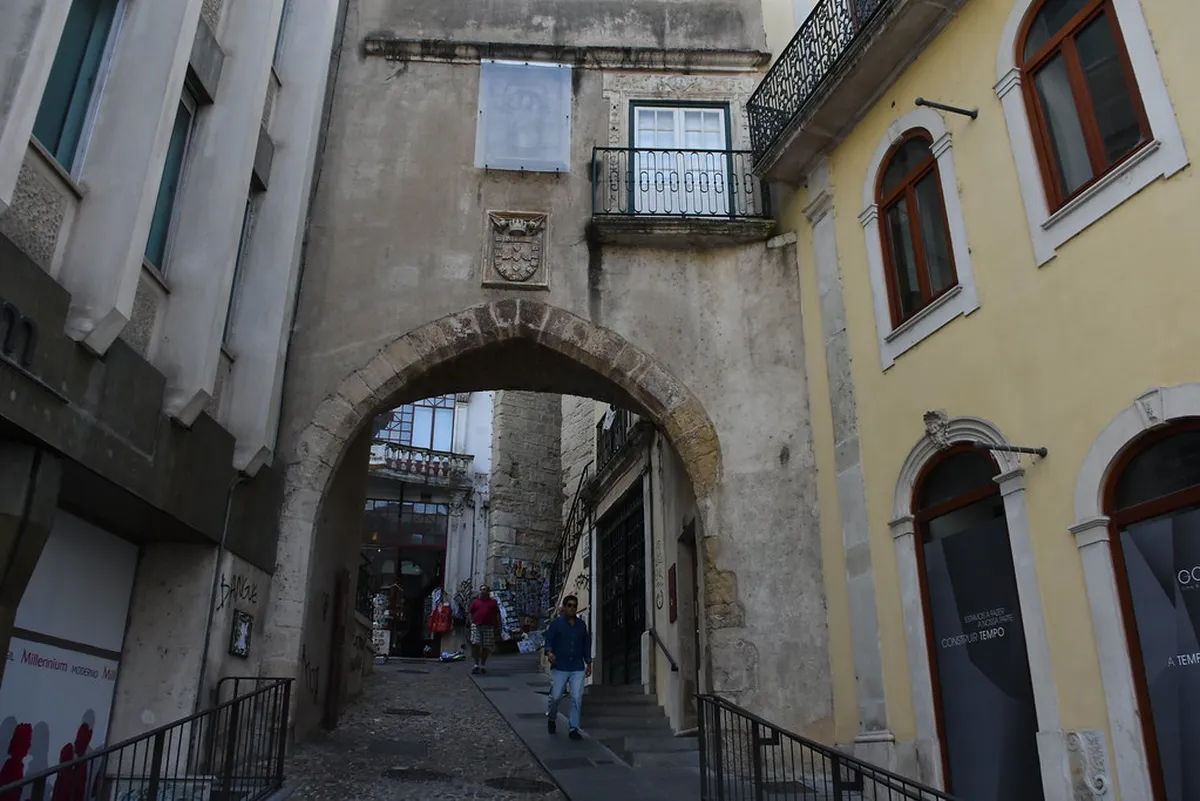 The medieval Arco de Almedina stone archway in Coimbra leading from Baixa into the historic upper city