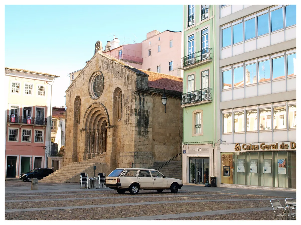 Historic church architecture with ornate details on a Coimbra street, reflecting centuries of religious heritage