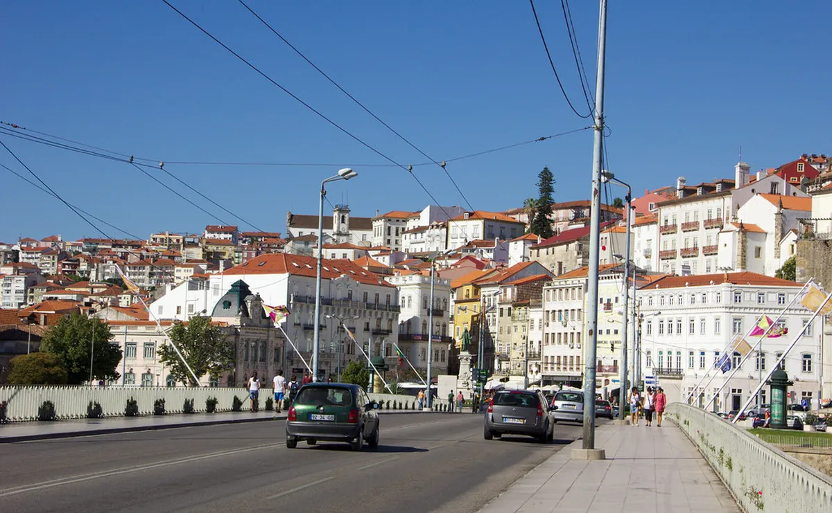 Panoramic view of Coimbra's historic skyline and the Mondego River from Ponte de Santa Clara bridge