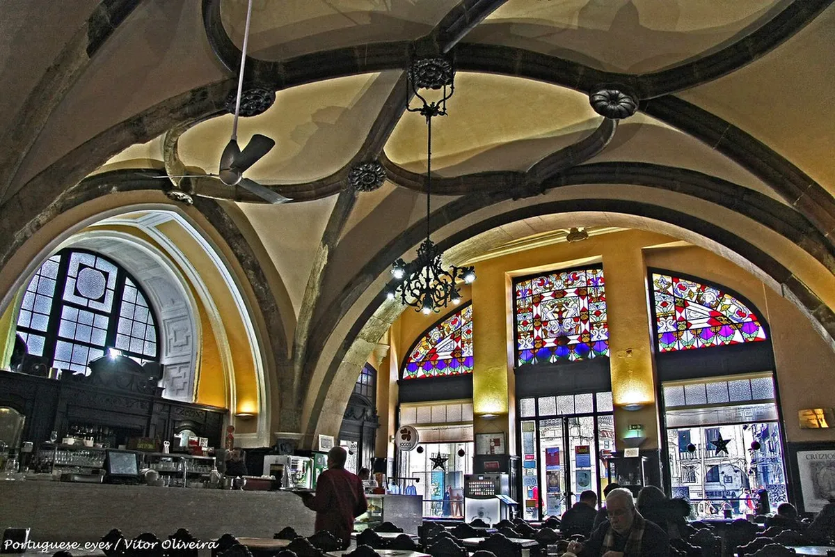 Interior of Café Santa Cruz in Coimbra, a historic cafe set inside a former church with vaulted ceilings