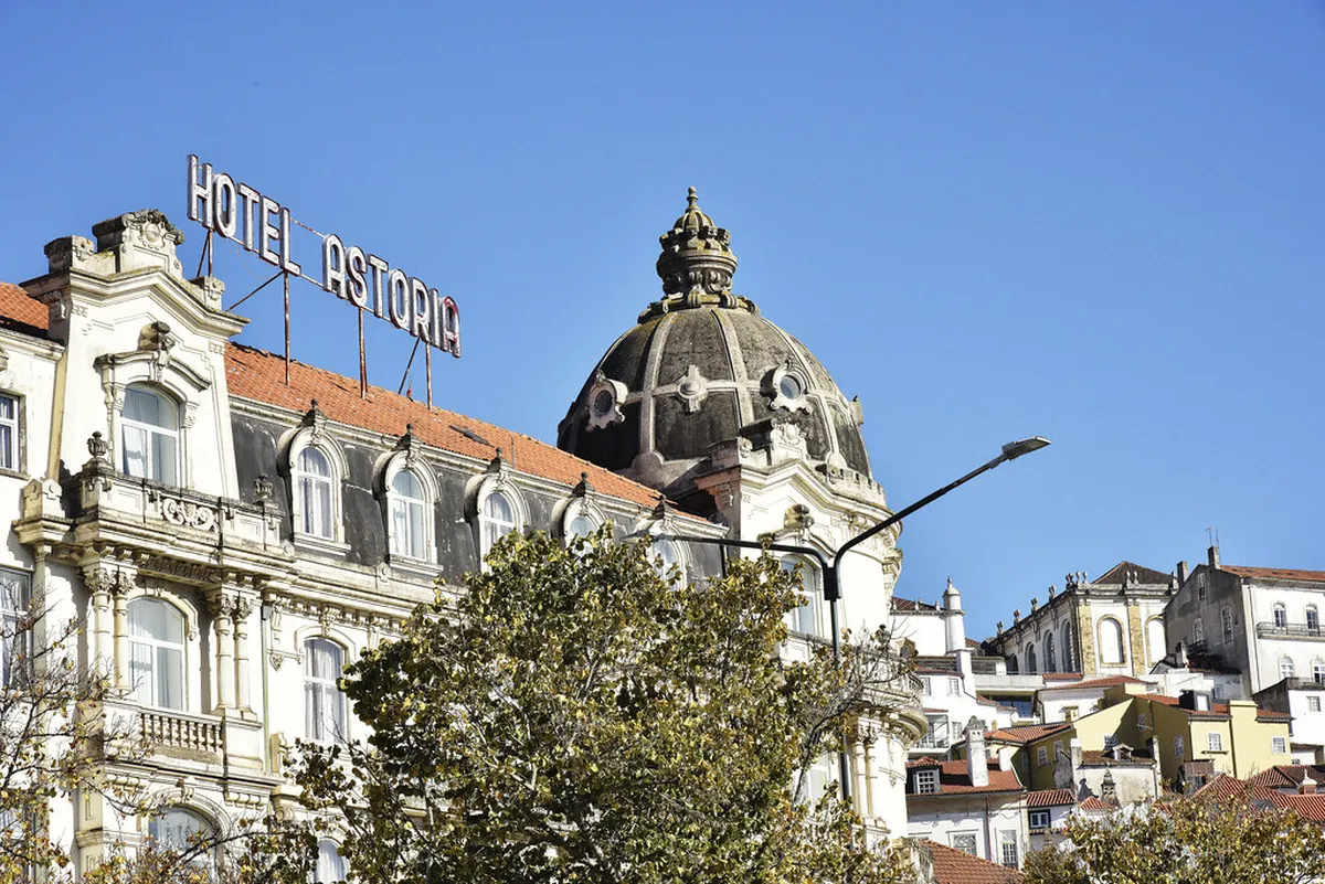 Baixa district street scene in Coimbra with traditional buildings lining a busy pedestrian thoroughfare
