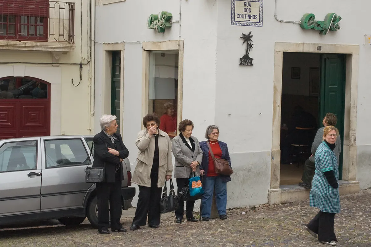 A Coimbra bus stop sign in the city center showing SMTUC route information for navigating Coimbra by public transport