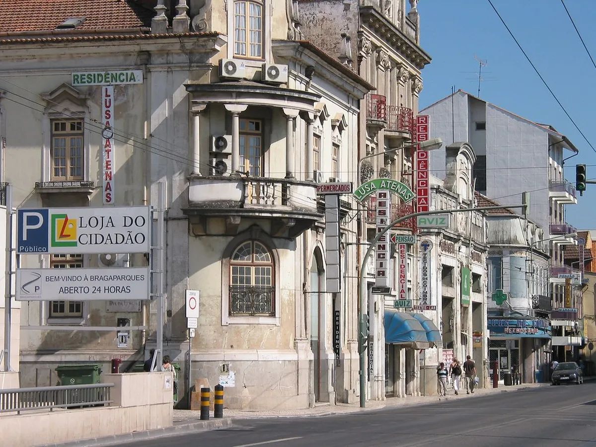 Coimbra Baixa district street scene with visitors exploring the historic city centre near the market area
