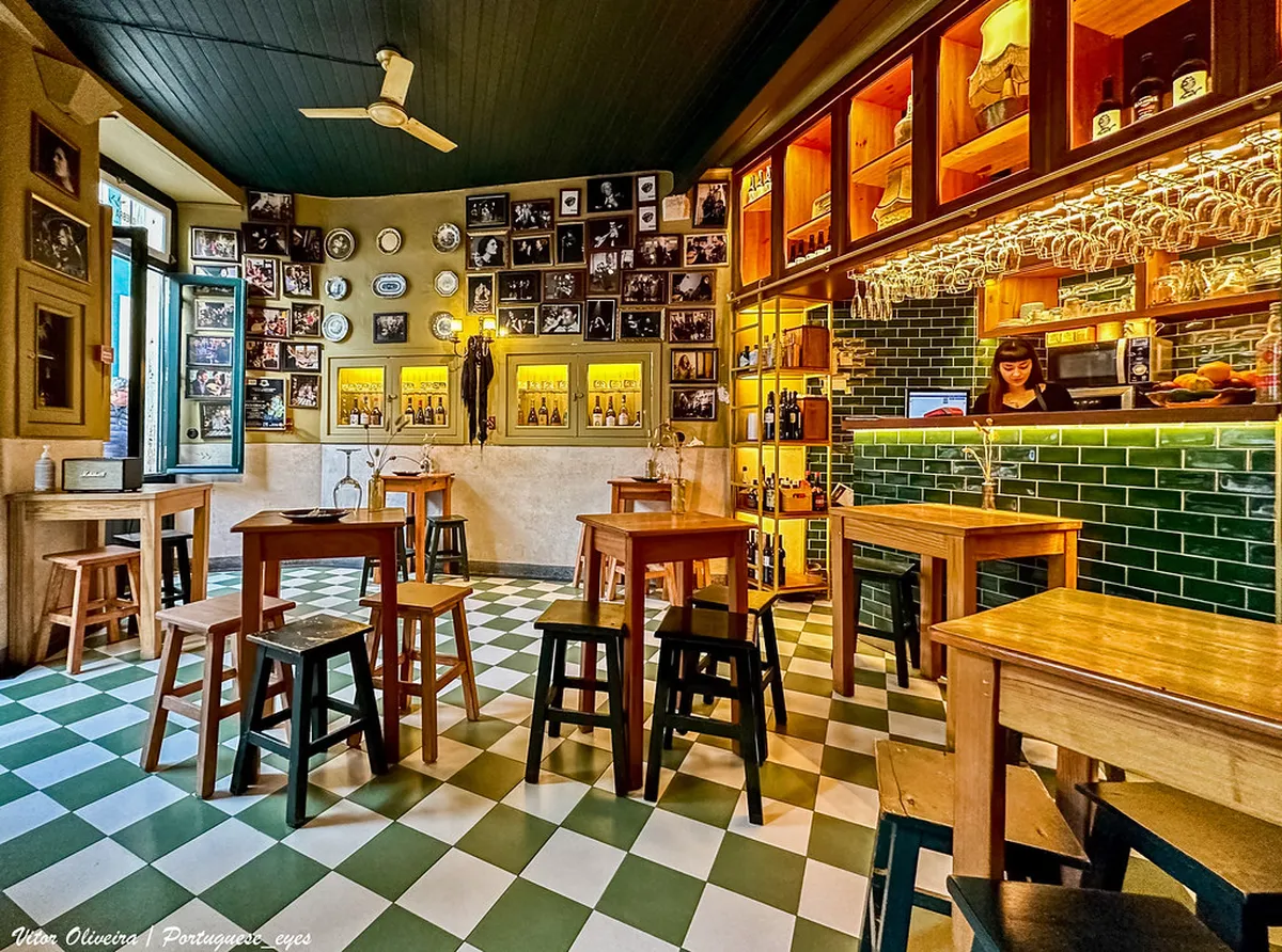A cozy Coimbra tasca restaurant interior with traditional Portuguese decor and local dining atmosphere