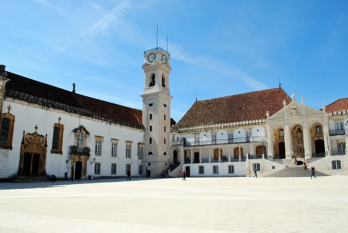 University of Coimbra historic campus buildings and tower rising above the city's ancient rooftops in Portugal