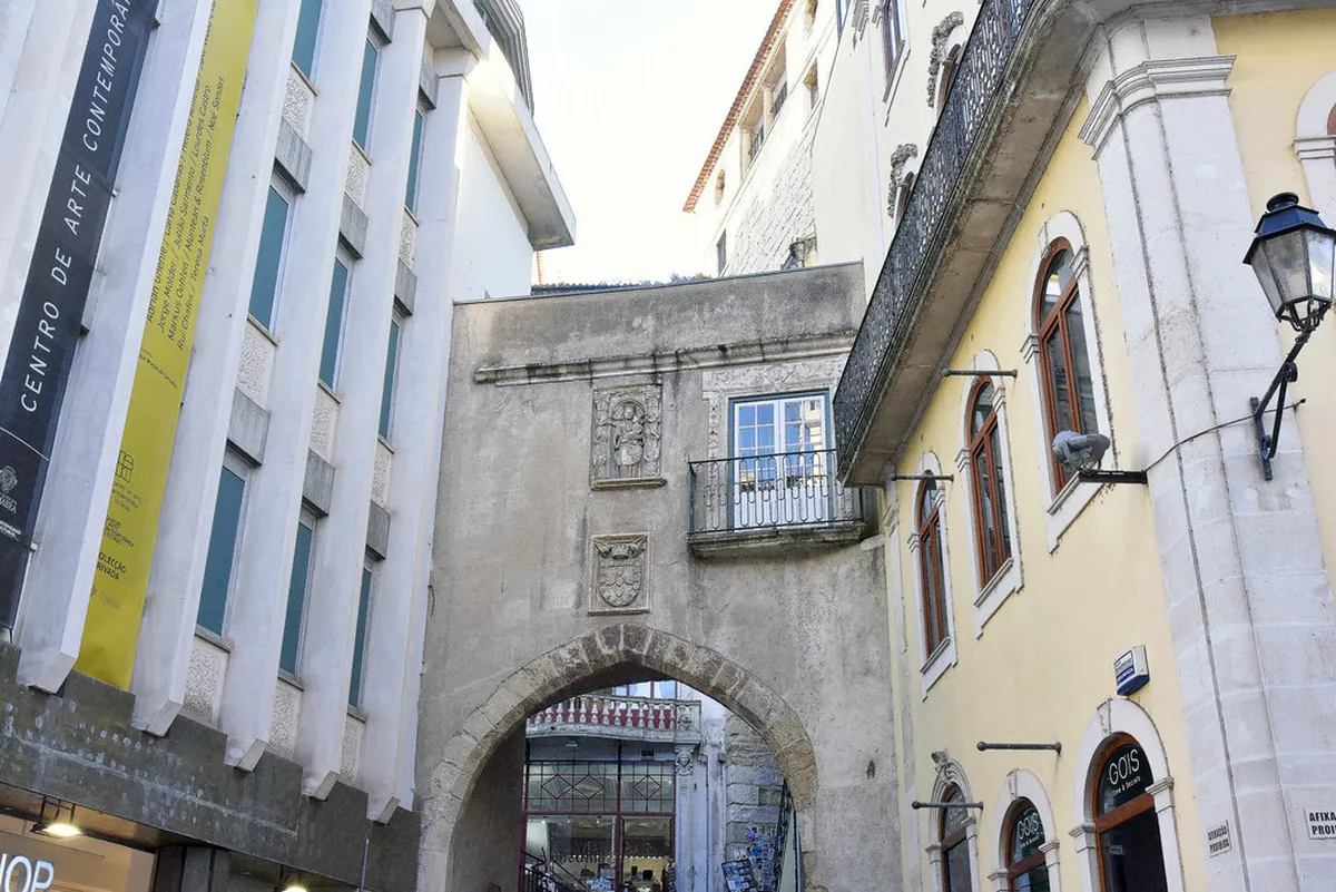 Coimbra Arco de Almedina medieval stone gateway arch leading into the historic old town streets