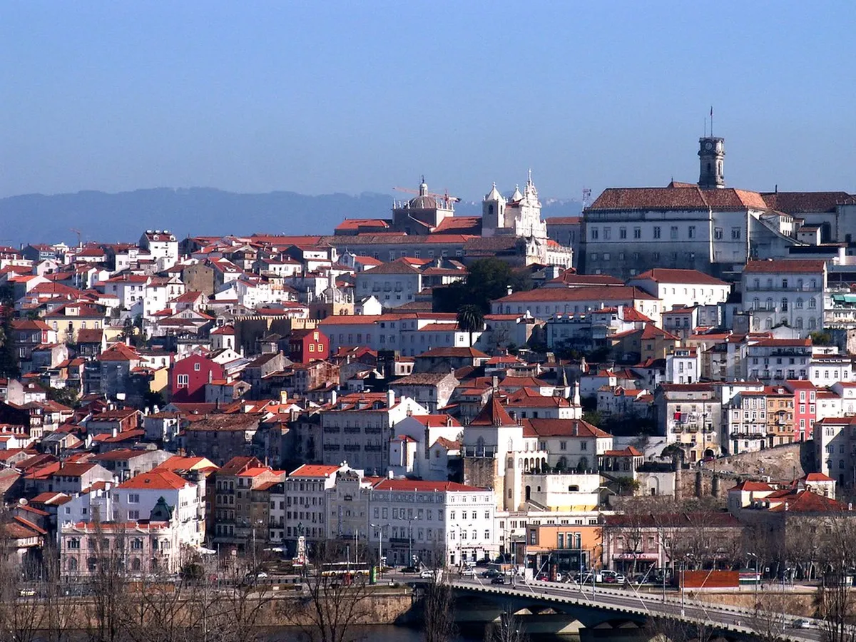 A historic student república building in Coimbra displaying its distinctive flag and centuries-old academic traditions