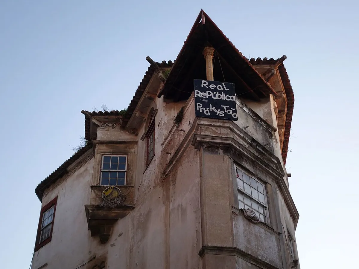 Historic Coimbra republicas student houses lining a narrow cobblestone street in the old university quarter
