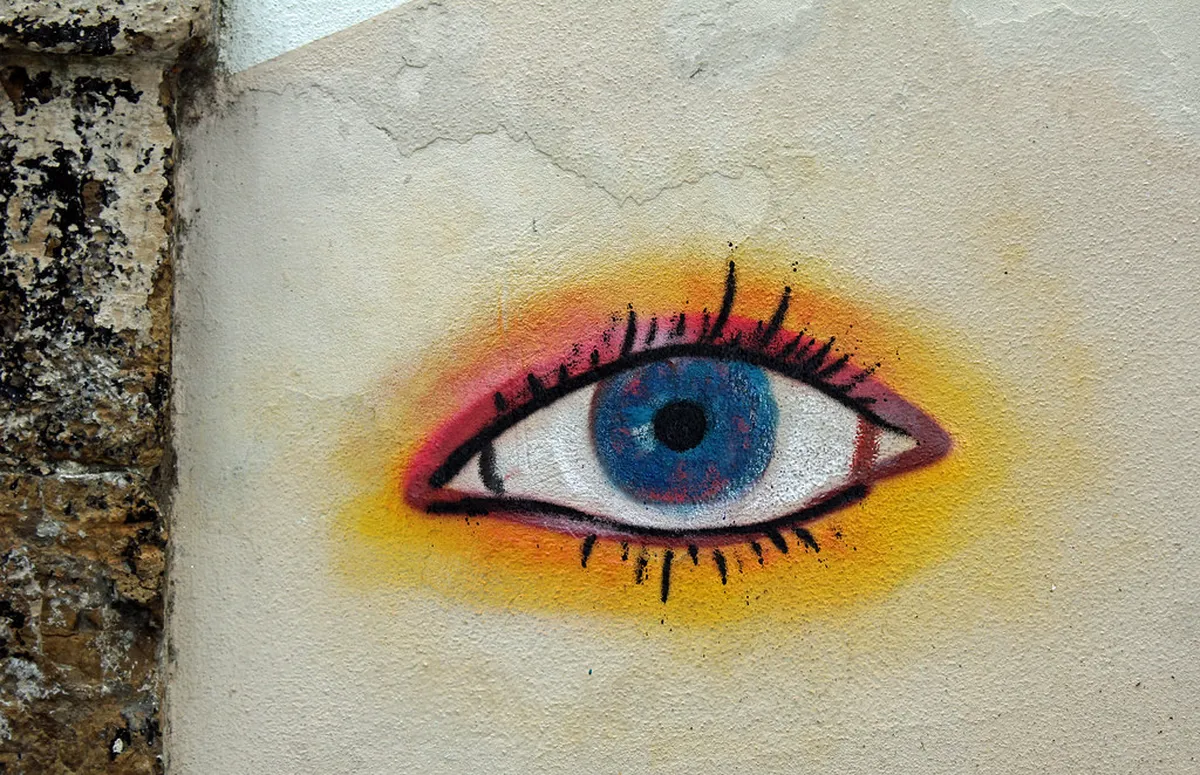 Coimbra Baixa district street art mural painted on a historic building wall in the city centre