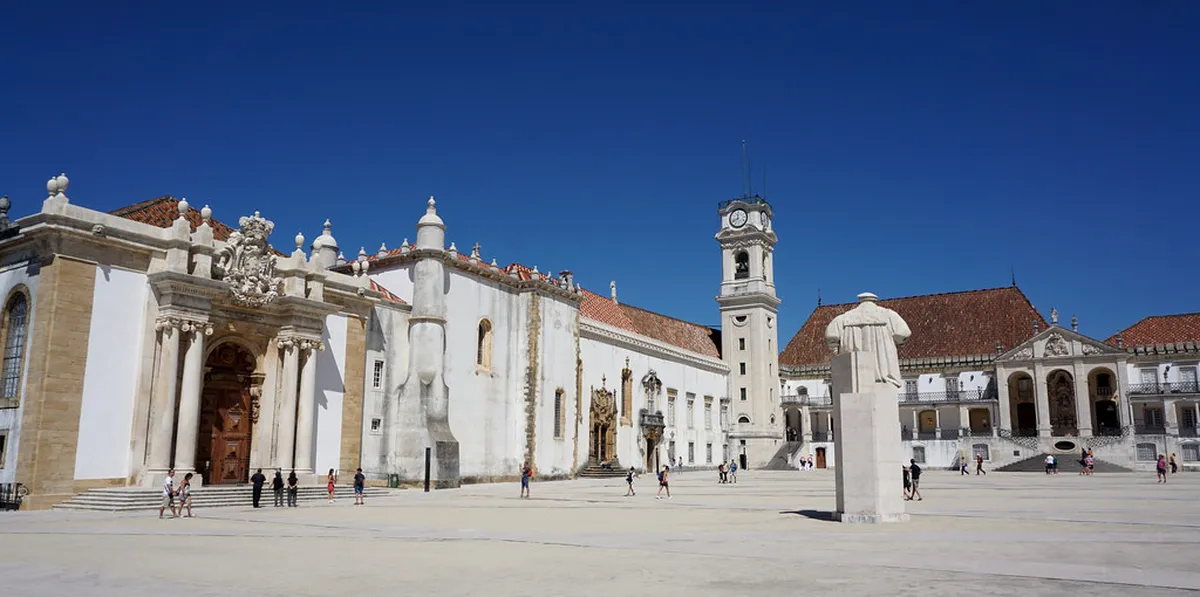 Coimbra University hilltop buildings and terracotta rooftops stretching across the historic Alta district