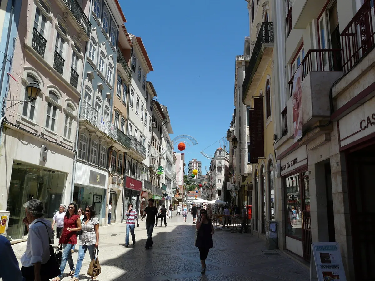 Coimbra Rua Ferreira Borges pedestrian shopping street lined with historic buildings and local boutique storefronts