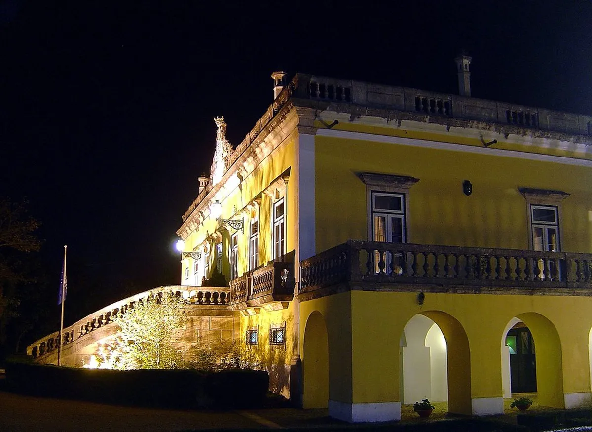 Lush garden and palace facade of Quinta das Lágrimas, Coimbra's most storied luxury hotel
