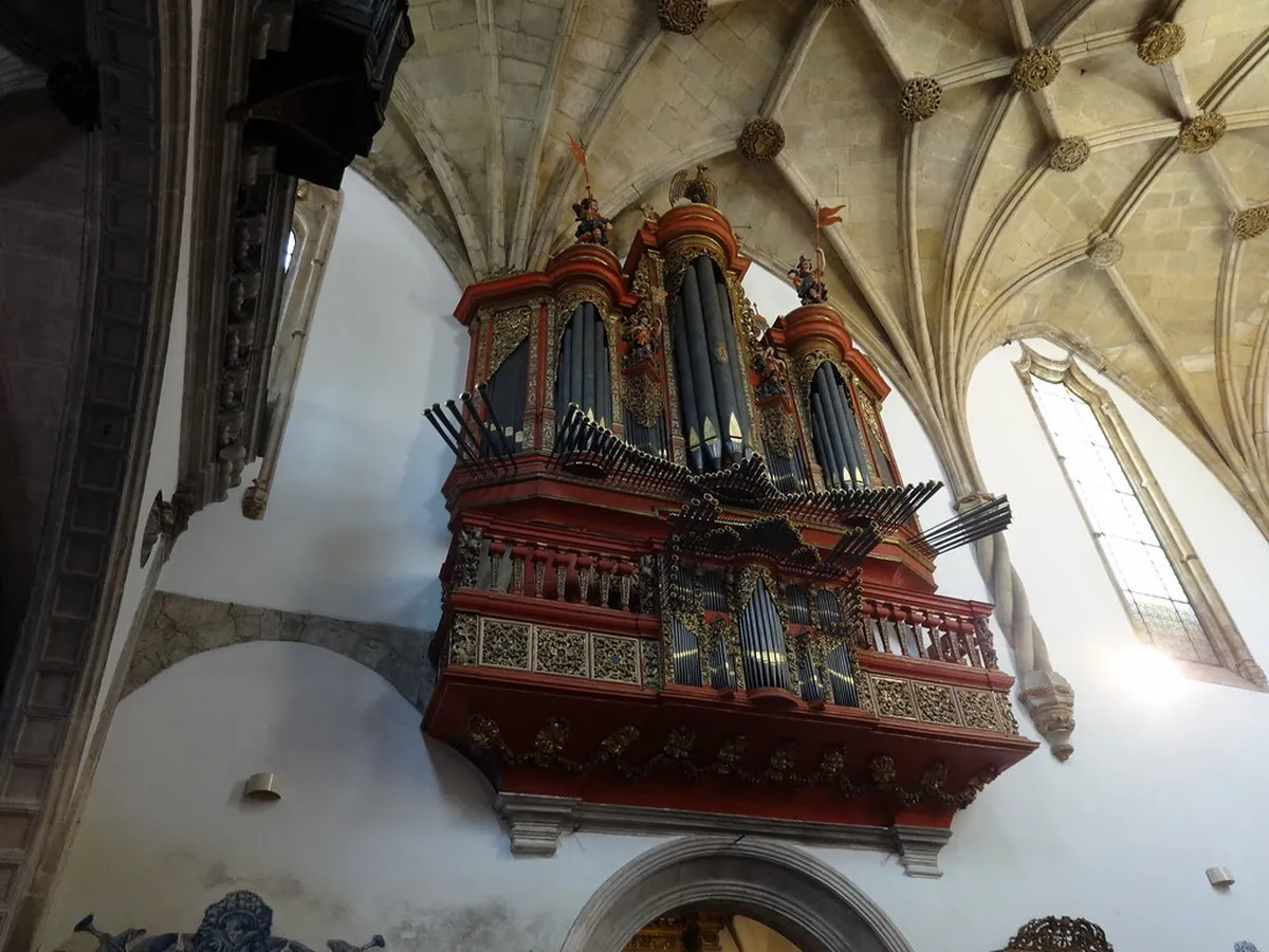 Ornate Manueline stonework and gilded altarpiece inside the Santa Cruz Monastery church in Coimbra