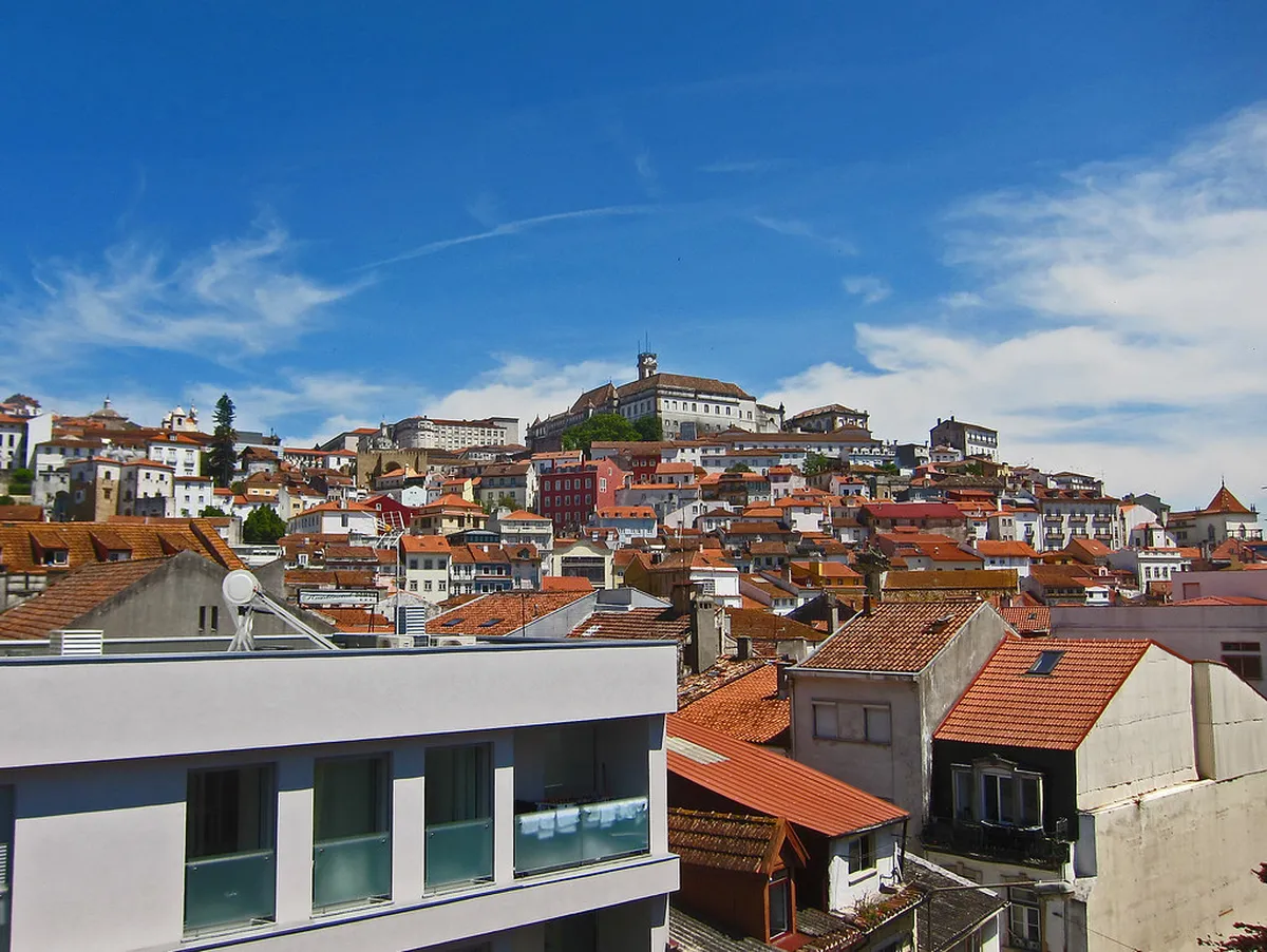 Coimbra university hill with historic academic buildings and cathedral towers visible against the skyline