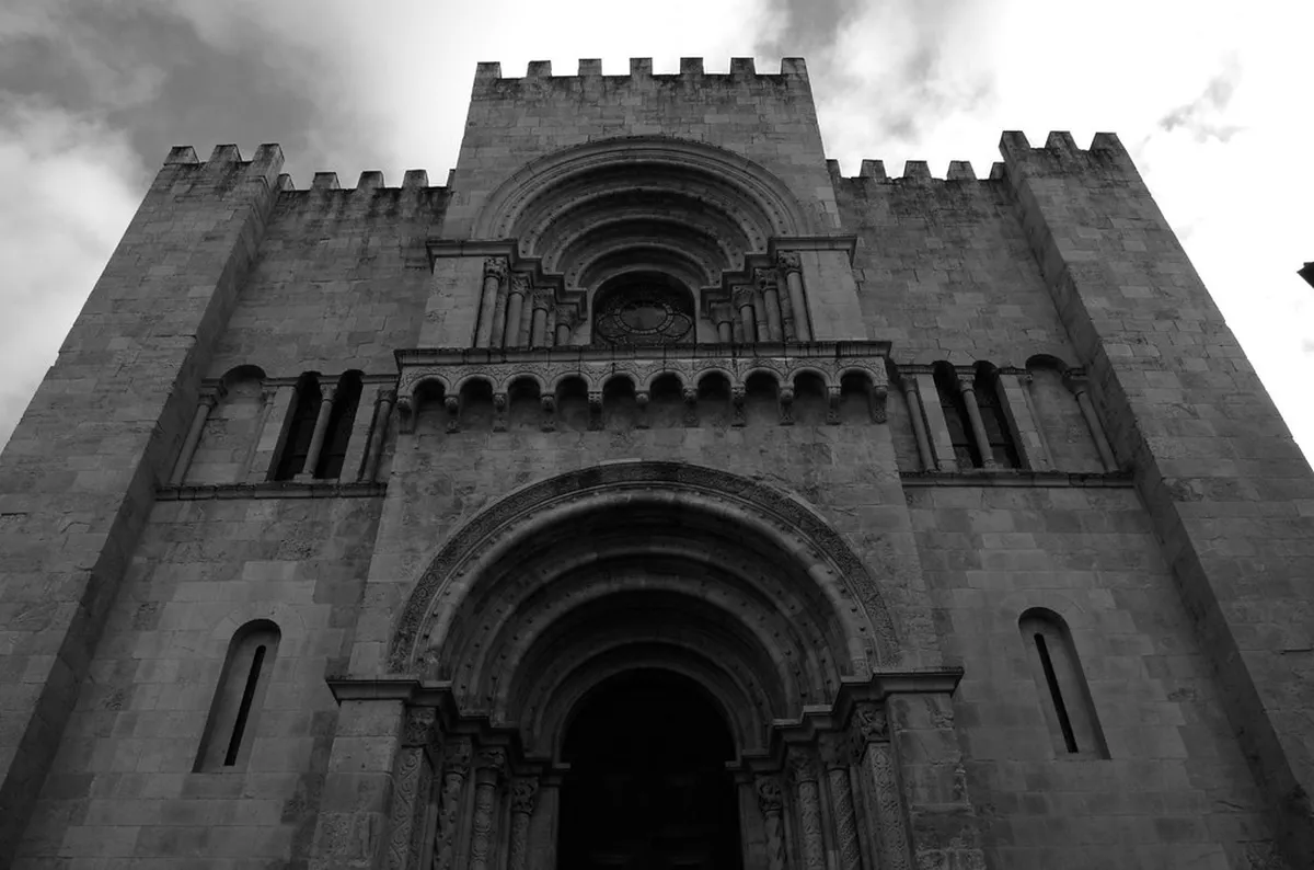 The ancient Sé Velha old cathedral of Coimbra rising above the medieval rooftops of the historic Alta district