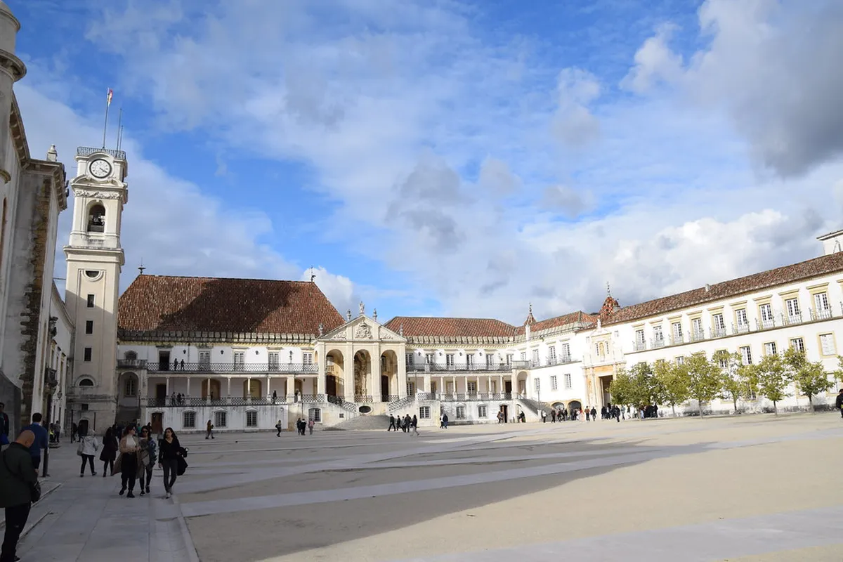 Narrow cobblestone streets winding through Alta Coimbra neighborhood with traditional Portuguese buildings