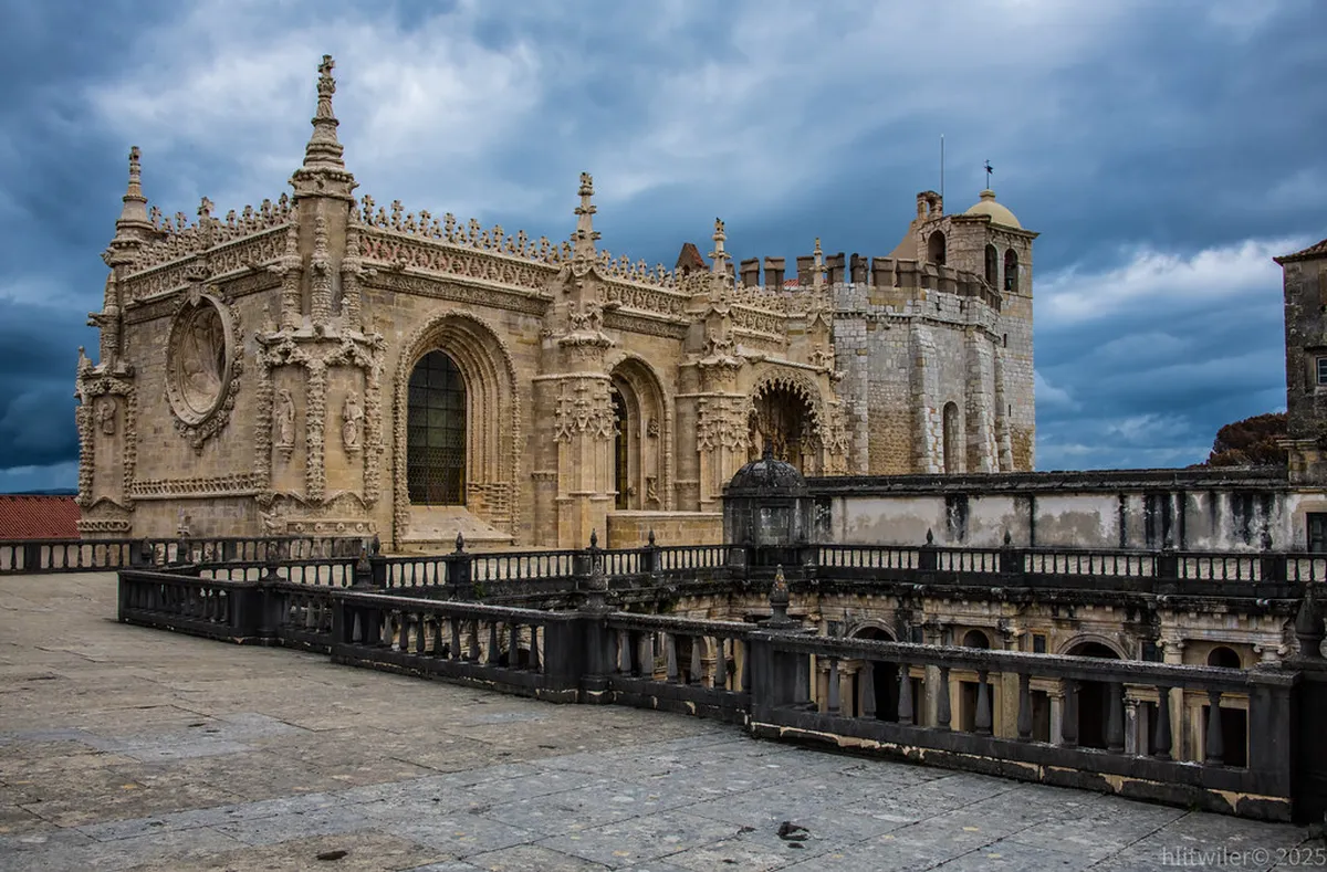 Historic medieval wall fragments and the Almedina Arch in the old quarter of Coimbra, Portugal