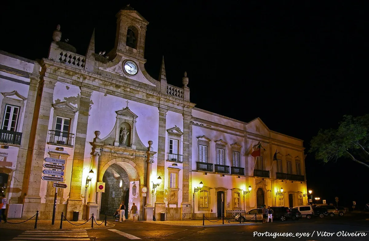 Evening ambiance along Faro's historic streets, with warm lights illuminating the charming dining scene after dark