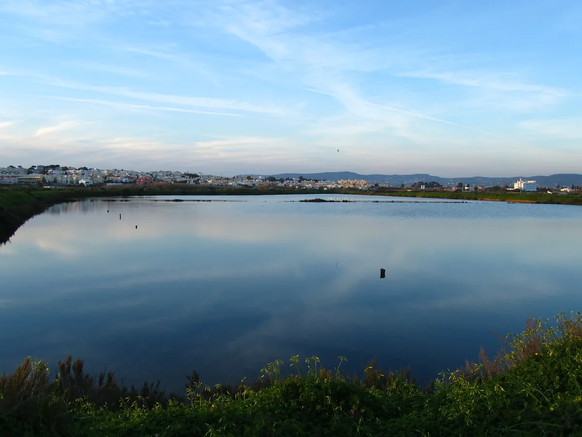 Scenic Faro Ria Formosa lagoon with golden light reflecting over calm waters in the Algarve