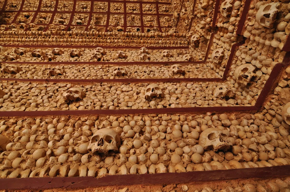 Ornate historic chapel interior in Faro with elaborate bone decorations covering the walls