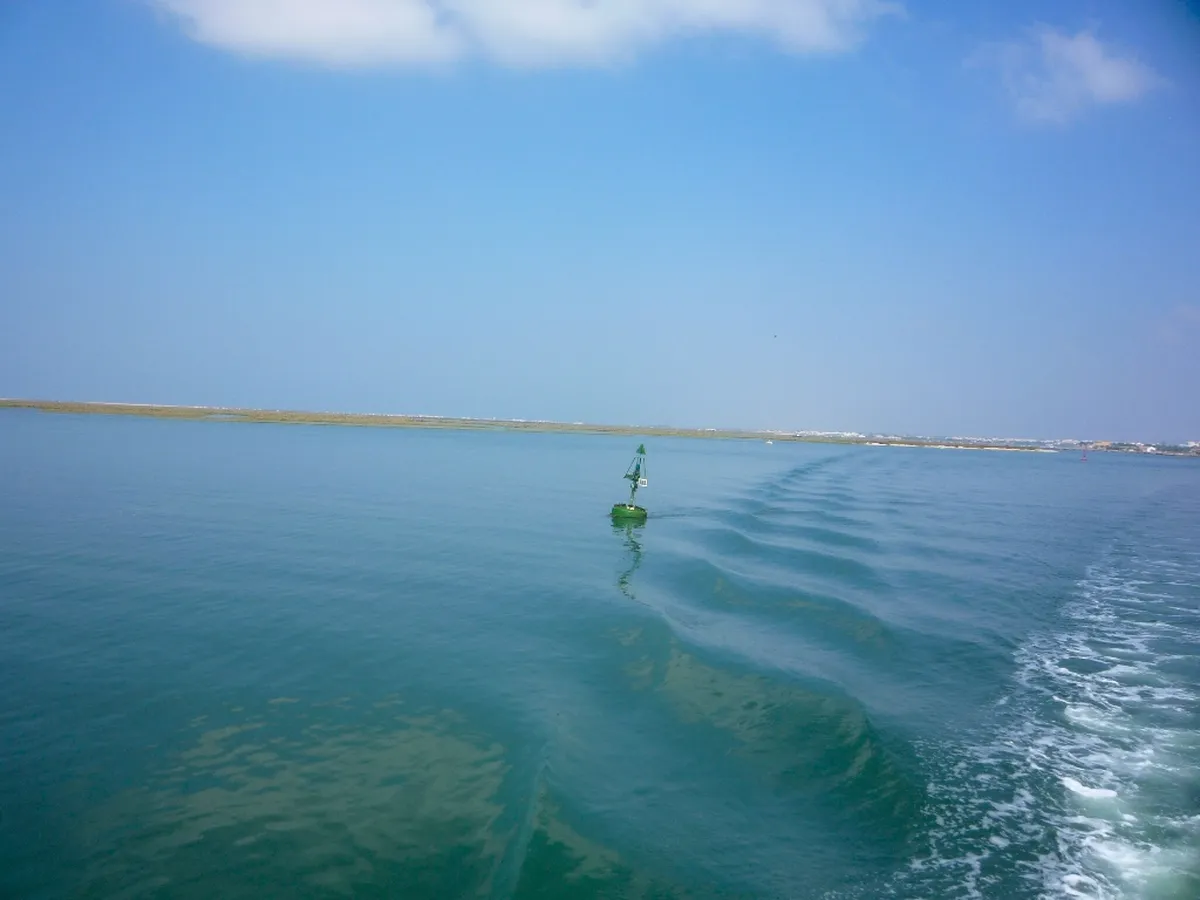 Calm lagoon waters and salt marshes of Ria Formosa Natural Park near Faro, a protected wetland paradise in southern Portugal