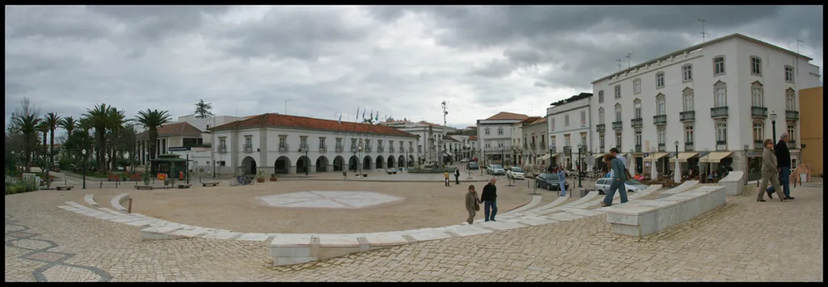 Historic Portuguese town with Roman bridge and castle ruins over river in Tavira