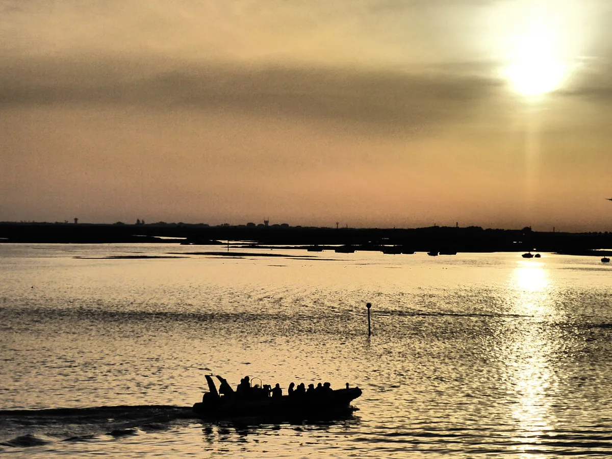 Ria Formosa lagoon with sandbar islands and boat in Faro, Portugal
