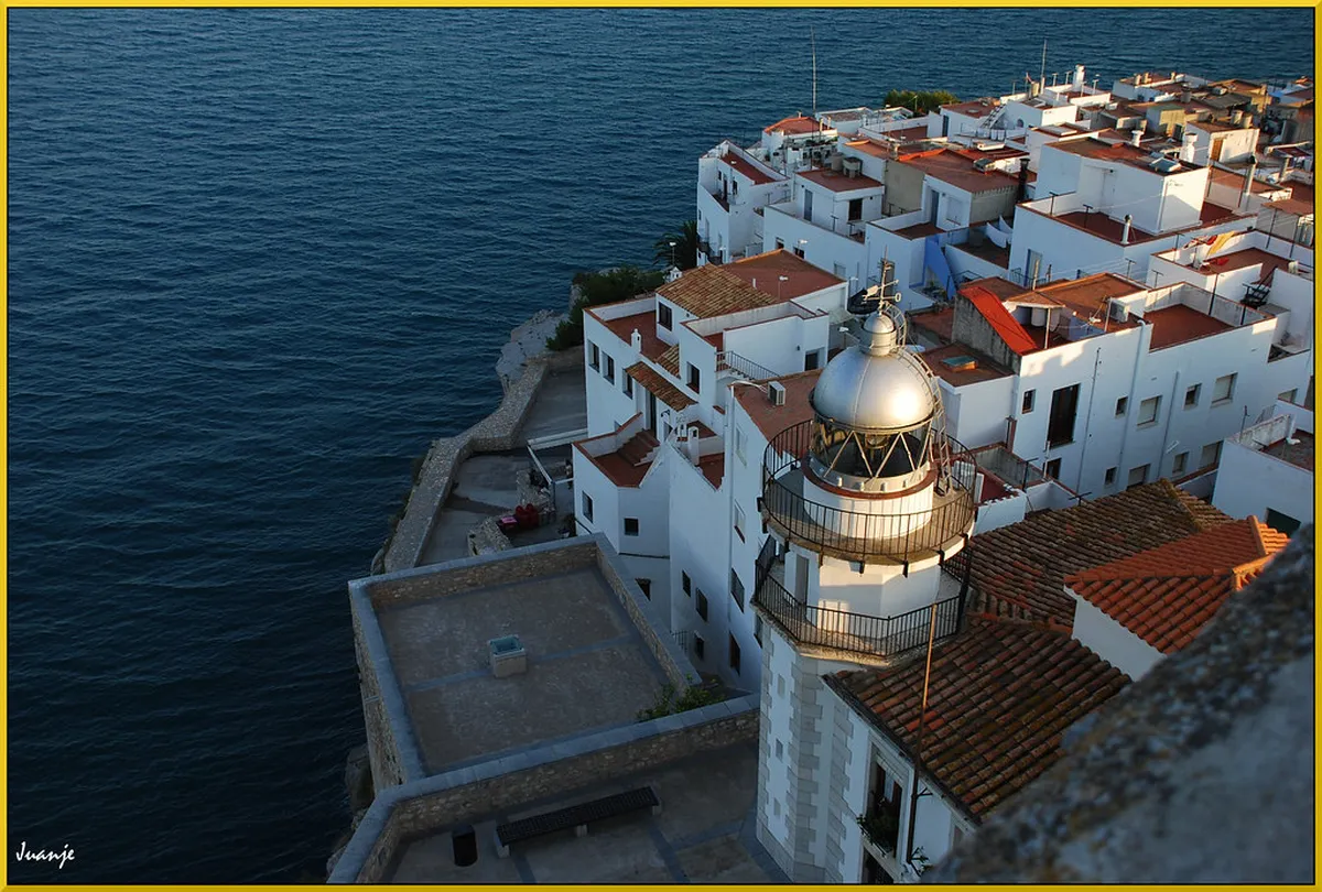 Panoramic rooftop view over Faro's historic district with red-tiled rooftops and the Ria Formosa in the background