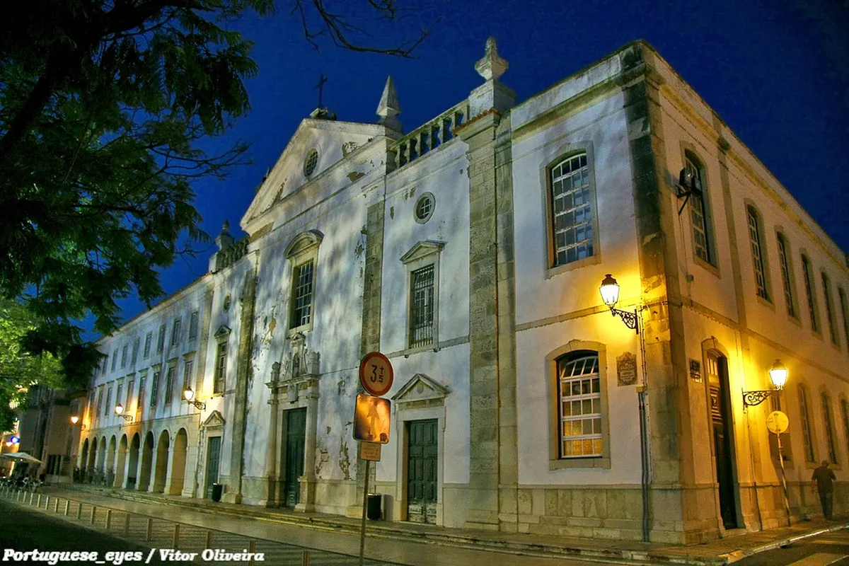 Igreja da Misericórdia in Faro, Portugal, showcasing its elegant Renaissance-style stone entrance with classical columns near the historic Arco da Vila