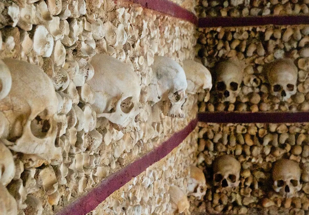 Interior of the Faro Chapel of Bones displaying skulls and remains of Carmelite monks along its walls