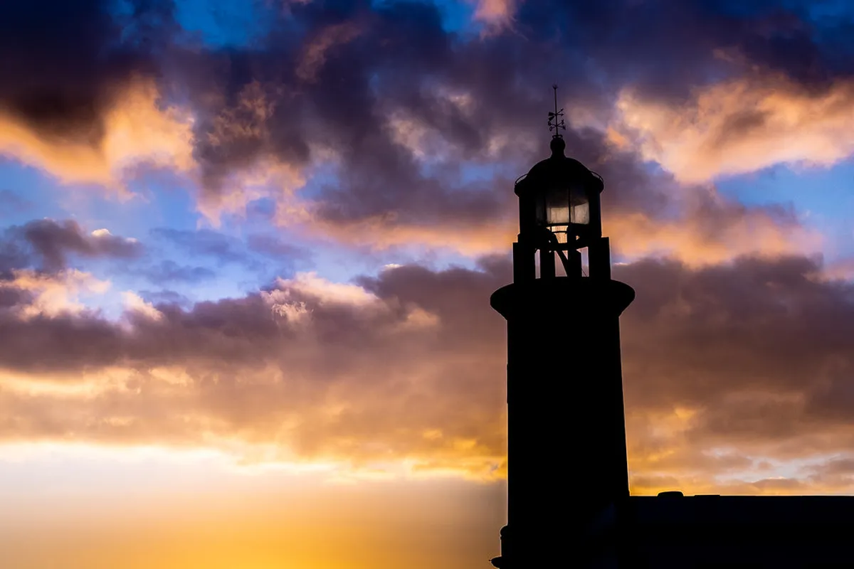 Warm golden hour light washing over Faro cathedral and Largo da Sé square at sunset