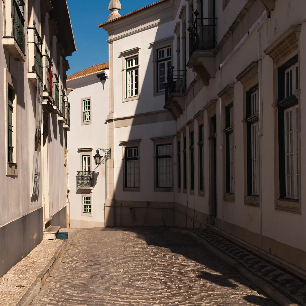 Faro city street scene with vehicles passing through the historic Algarve town center