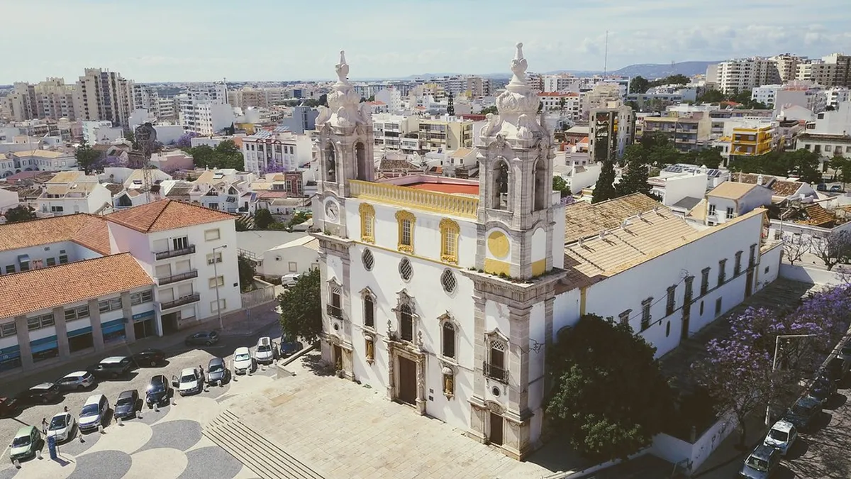 Faro Cathedral tower rising above the terracotta rooftops of the Old Town historic district