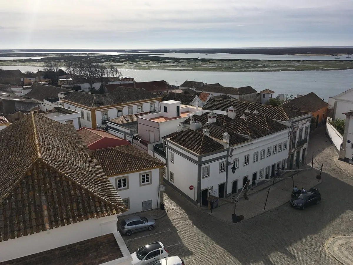 Igreja do Carmo's ornate Baroque facade with twin bell towers in Faro, Portugal