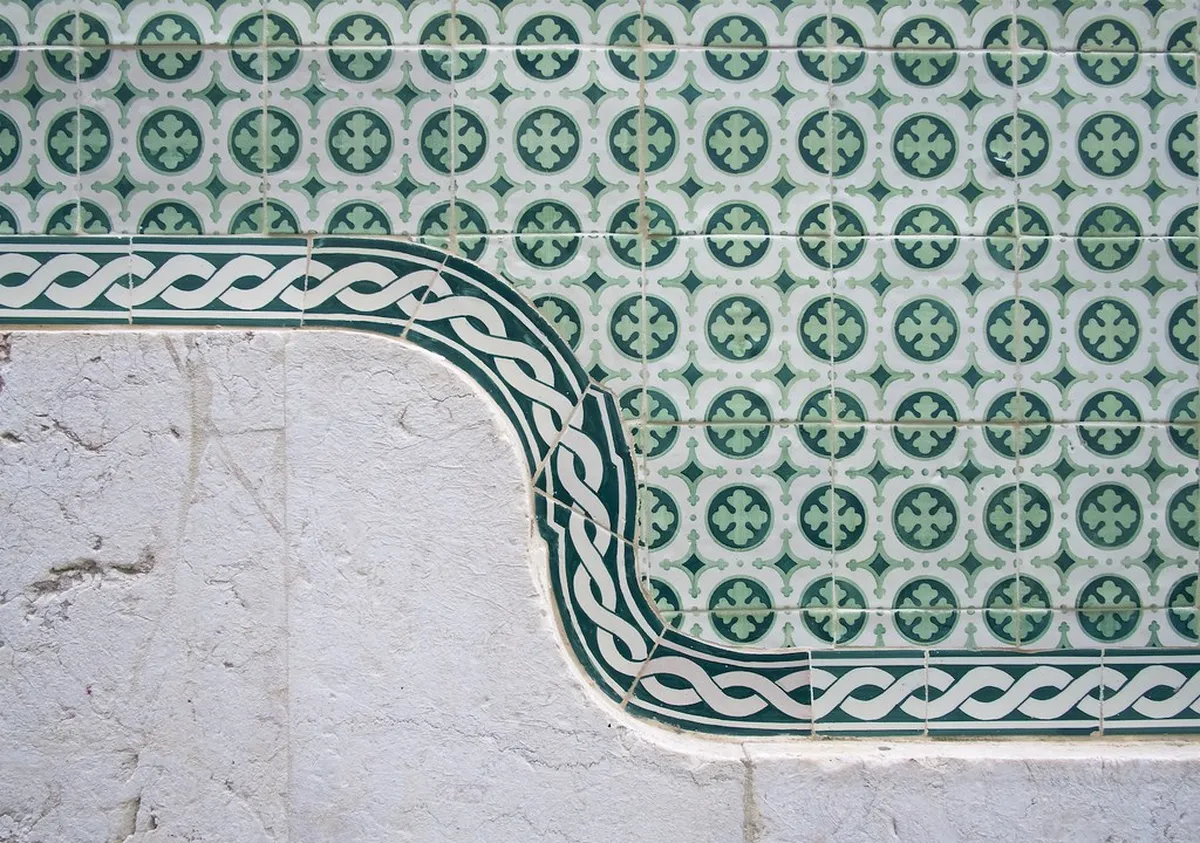 Colorful azulejo tiles decorating a traditional building facade in Lisbon's Alfama district