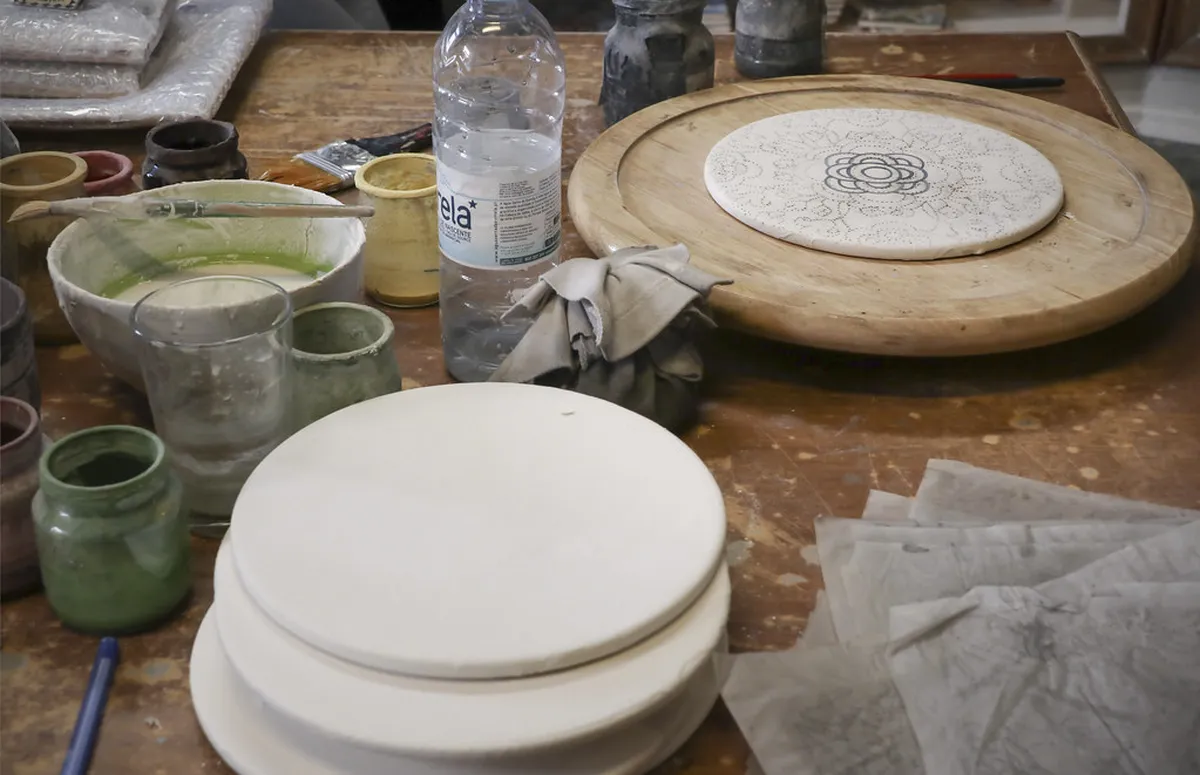 A ceramic workshop space in Lisbon with handcrafted pottery and tiles ready for painting sessions