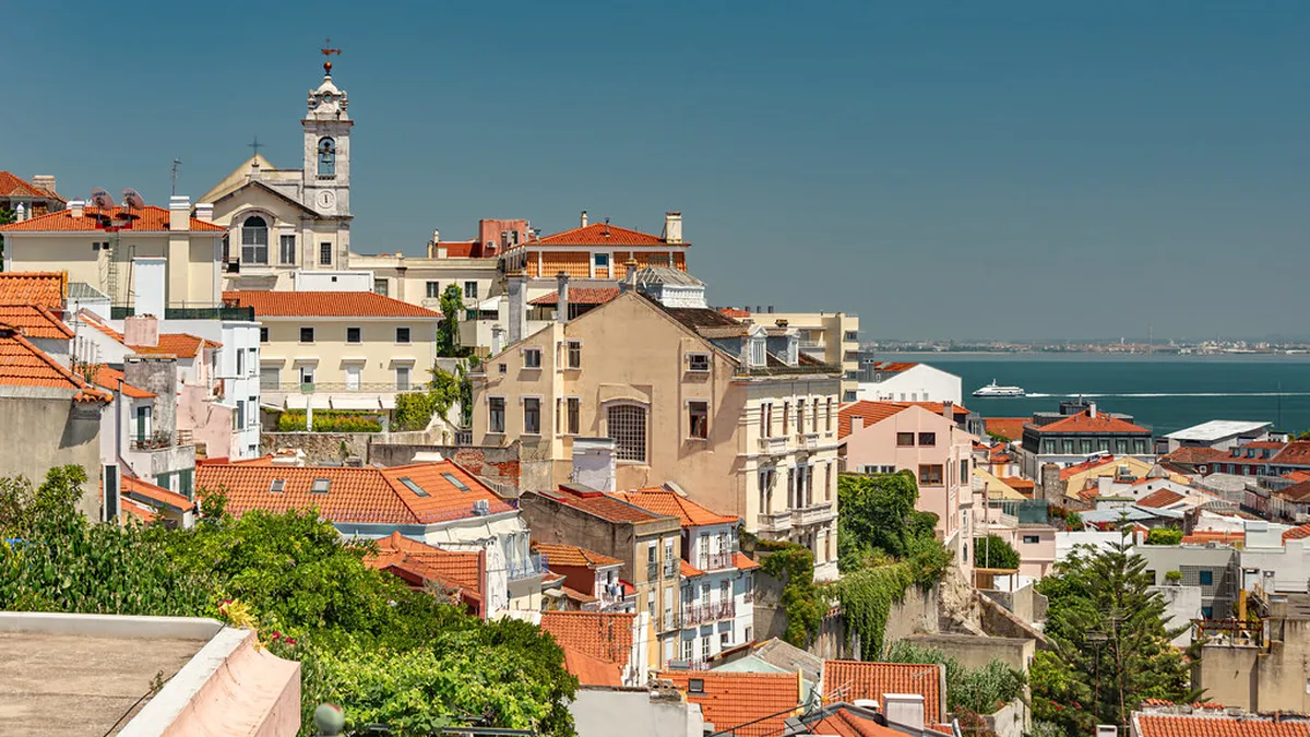 Miradouro de Santa Catarina viewpoint in Lisbon with panoramic views over the Tagus River at sunset