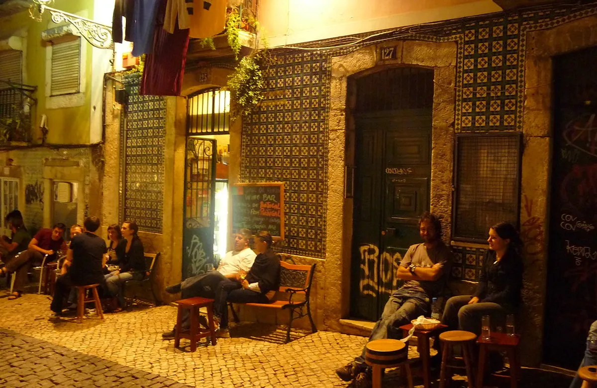 Intimate Lisbon wine bar in Bairro Alto with bottles and local Portuguese wines on display