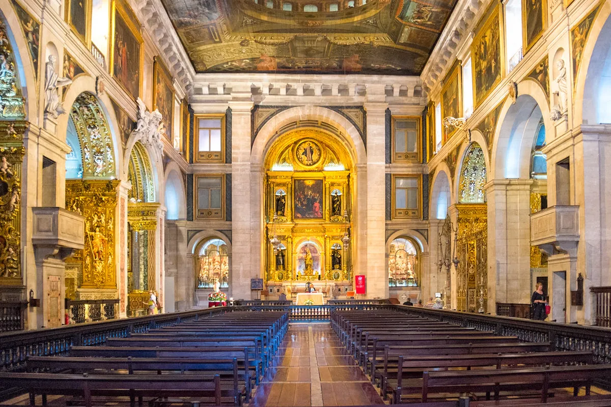 Ornate gilded interior of Igreja de Sao Roque in Lisbon, featuring elaborate chapel decorations and azulejo tiles