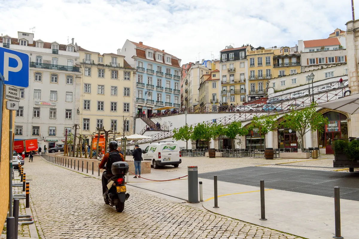 Colorful street life in Lisbon's Baixa district, the heart of budget travel accommodation in the city