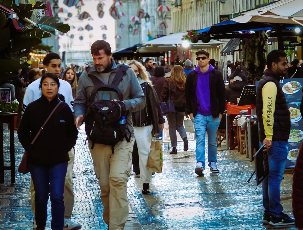 Shoppers and visitors strolling along Rua Augusta, Lisbon's main pedestrian street in the Baixa district