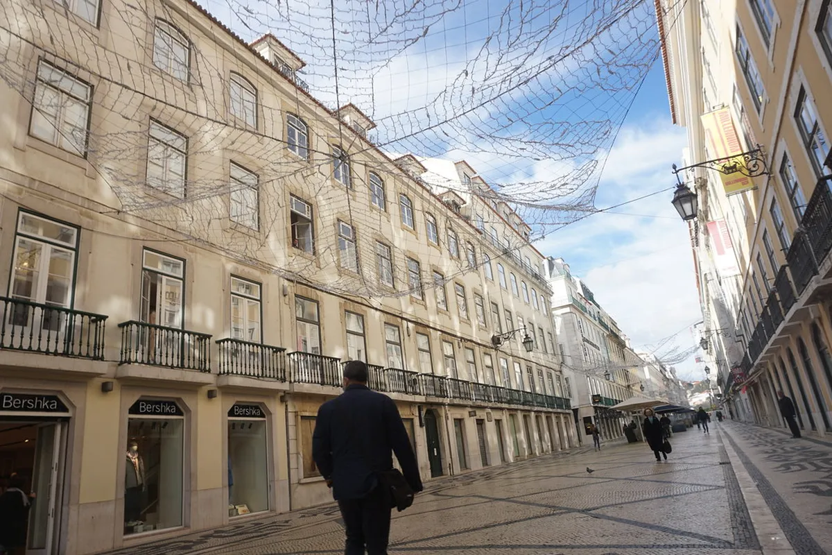 Rua Augusta pedestrian street in Lisbon lined with Pombaline neoclassical buildings and the famous triumphal arch