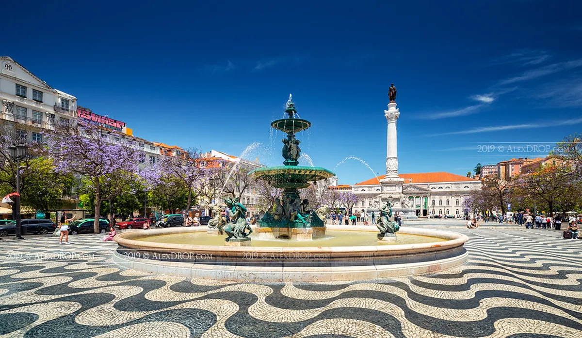 Rossio Square in Lisbon with its distinctive black-and-white wave cobblestone pavement and the column of Dom Pedro IV