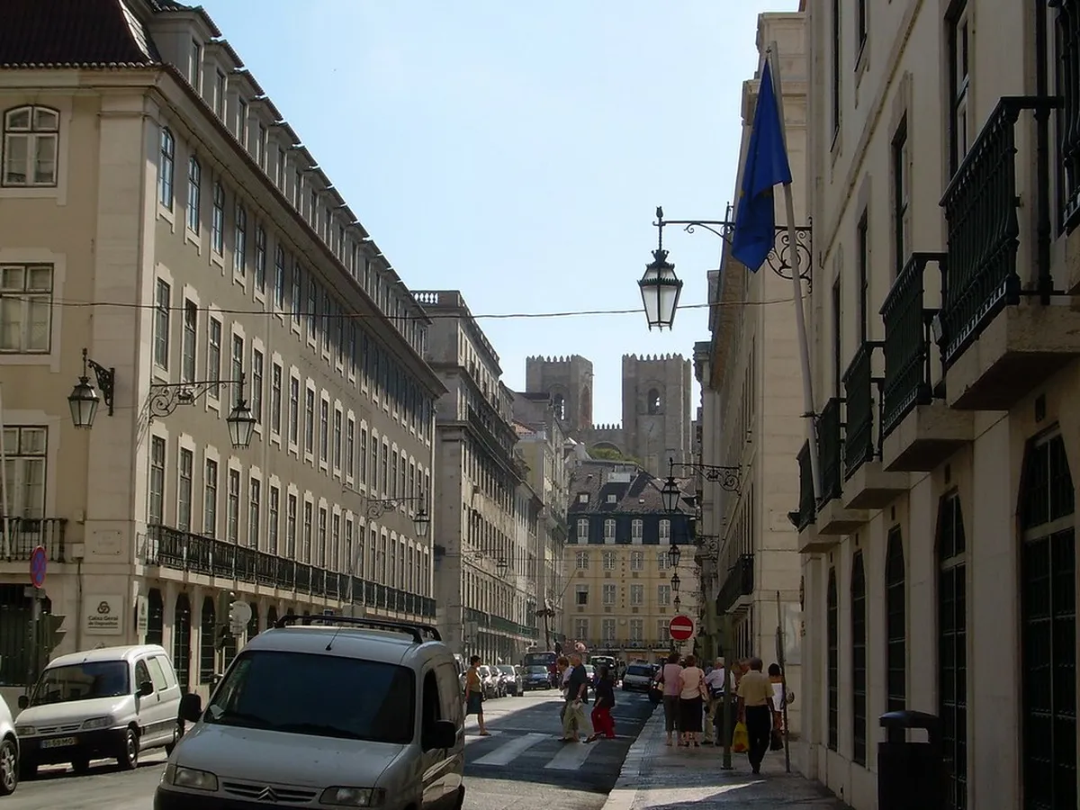 Lisbon Baixa Pombaline-style building facades with uniform classical design lining a wide straight street