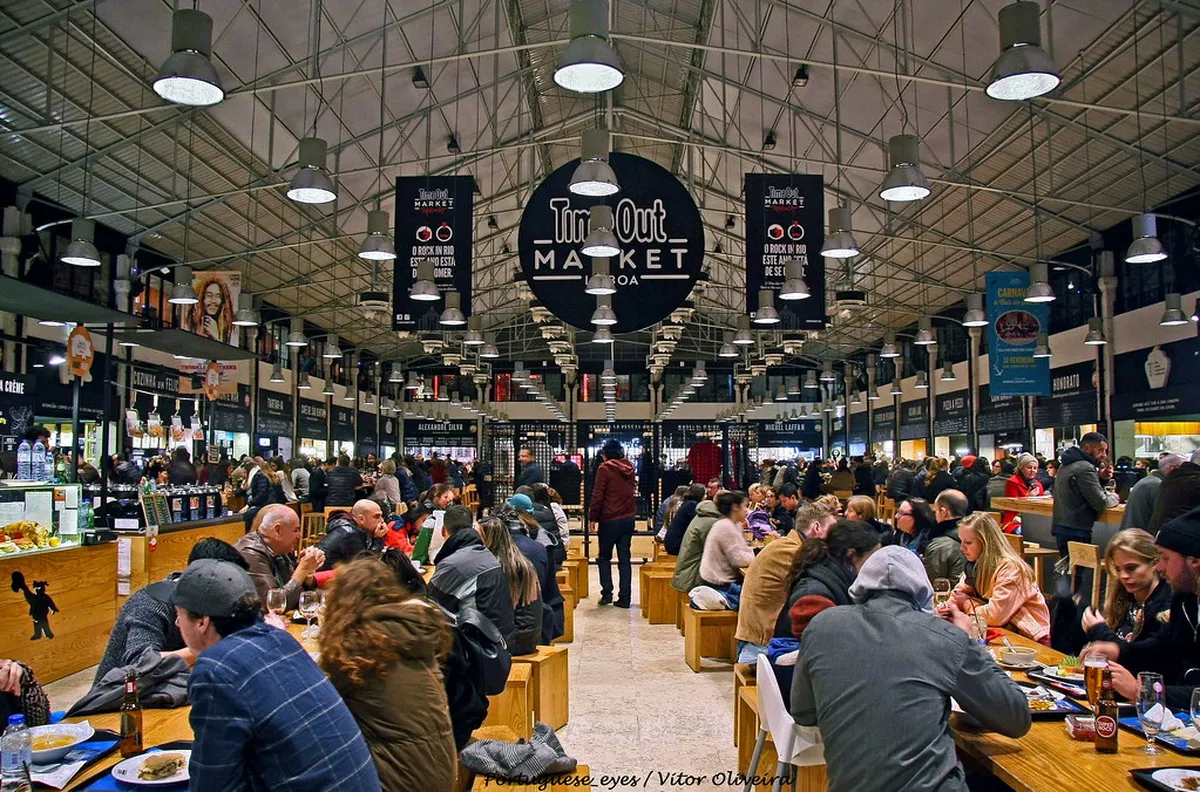 Lisbon's Time Out Market at Mercado da Ribeira bustling with visitors sampling Portuguese cuisine