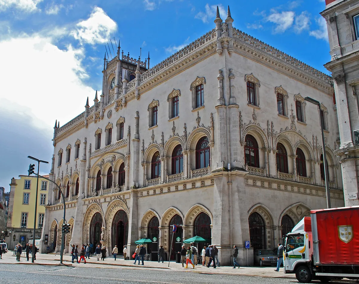 Rossio Station ornate Neo-Manueline facade in central Lisbon with arched doorways and decorative stonework