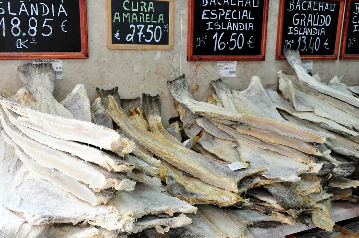 Colorful fresh produce and local goods at a Lisbon neighborhood market stall
